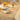 Decorative table setting with floral-patterned tablecloth, glasses, and plates.