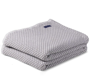 Image shows Faribault Mill’s Dove Grey bed blanket, folded