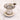 Metal tea strainer on a white marble surface