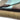 Stack of fabric swatches in brown, green, and beige on a white background