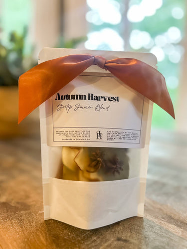 Packaged product labeled 'Autumn Harvest' with a decorative bow on a wooden surface.