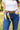 Model has silk scarf used as a belt on denim jeans paired with a white top