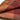 Close-up of a folded fabric with a checkered pattern in shades of brown and red.