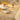 Decorative table setting with floral-patterned tablecloth, glasses, and plates.
