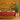 Dining room with a Christmas tree, table set for a meal, and yellow walls.