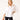 Woman wearing a white blouse and black pants holding a red handbag on a white background