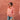 Woman wearing a pink striped shirt and sunglasses, standing against a textured red wall.