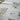 White cotton table runner iwth fronds printed on it