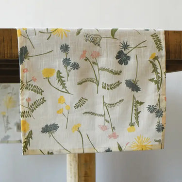 Floral patterned fabric on a wooden hanger against a white background