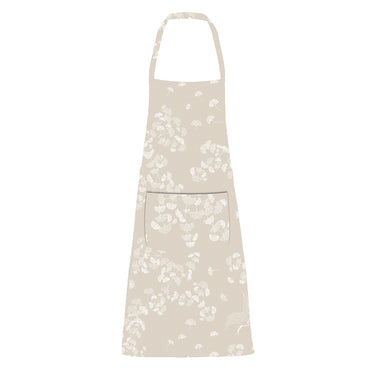 A tablecloth with a floral pattern in shades of cream and grey, displayed on a set table with dishes and decorative items.