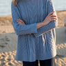 Mersea cable-knit Cotswold sweater in Misty Blue. One size, features a side-slit
