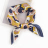 Floral square scarf in Navy. Features Pink, white and yellow flowers with a navy border