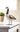 Decorative goose figure on a white surface with a blurred background