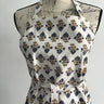 Floral patterned apron on a mannequin against a white background